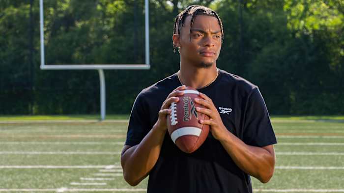 Justin Fields models Reebok's football apparel.
